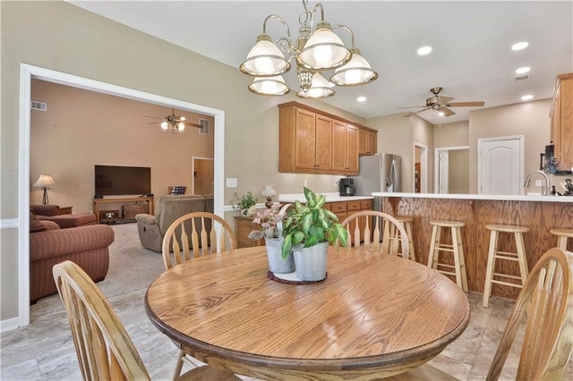 dining room with ceiling fan and sink