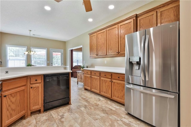 kitchen featuring sink, hanging light fixtures, stainless steel fridge, dishwasher, and ceiling fan with notable chandelier