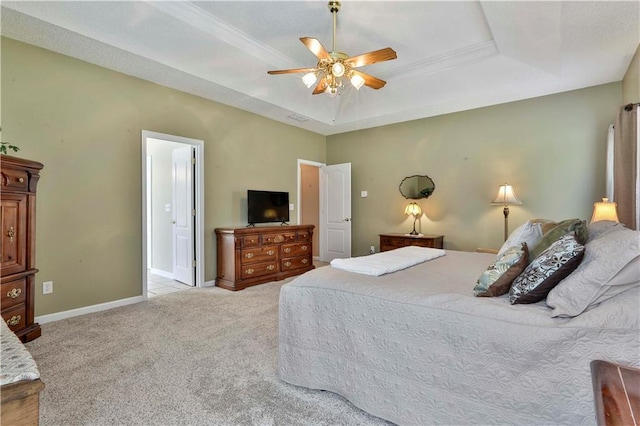 bedroom with ceiling fan, light colored carpet, and a raised ceiling