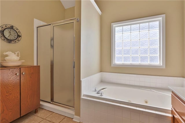 bathroom featuring independent shower and bath, vanity, and tile patterned flooring