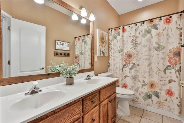 bathroom featuring walk in shower, vanity, toilet, and tile patterned flooring