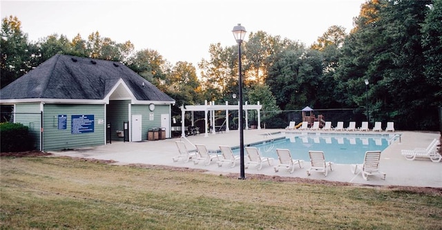 view of pool featuring a patio area and a lawn