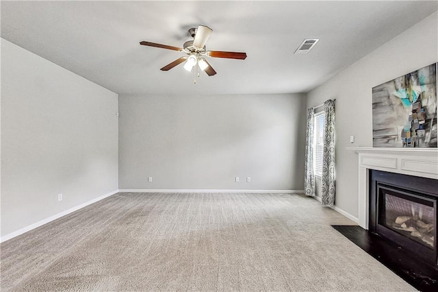 unfurnished living room featuring ceiling fan and carpet