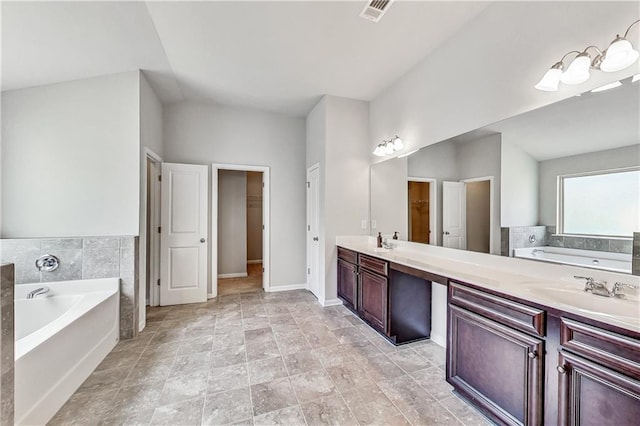 bathroom with vanity and a bath