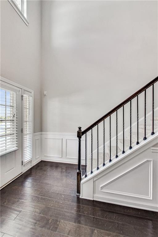 foyer featuring plenty of natural light and dark hardwood / wood-style flooring