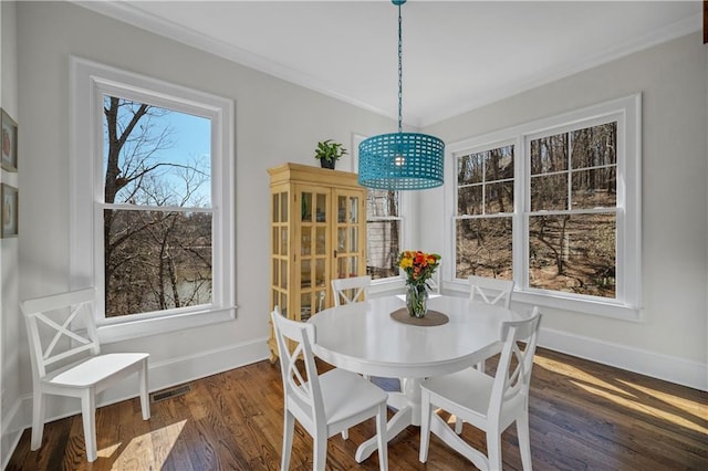 dining space featuring baseboards, dark wood-style floors, ornamental molding, and visible vents