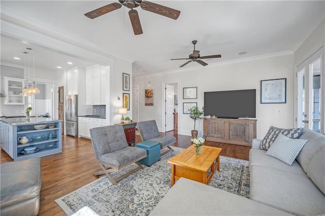 living room featuring crown molding, recessed lighting, ceiling fan, and wood finished floors