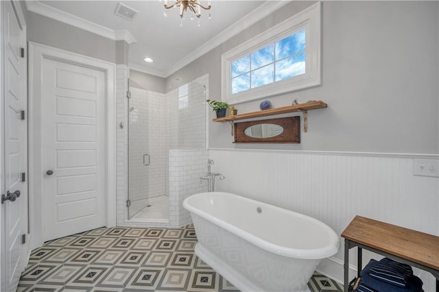 bathroom featuring a freestanding bath, wainscoting, a chandelier, ornamental molding, and a stall shower