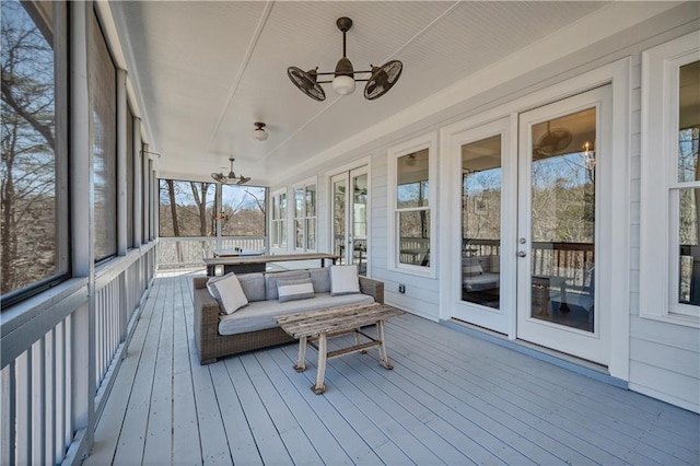 sunroom with french doors, a ceiling fan, and a healthy amount of sunlight