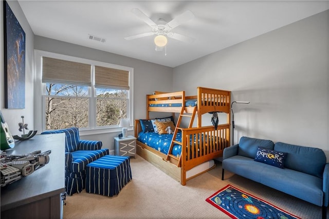 bedroom with visible vents, carpet flooring, and a ceiling fan