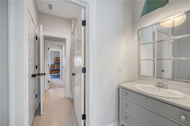 bathroom featuring vanity, baseboards, tile patterned flooring, and visible vents