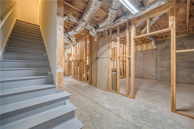 unfinished basement featuring stairs