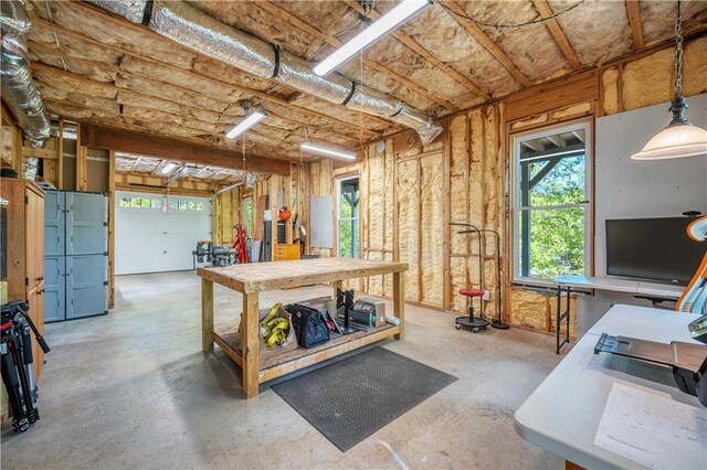 misc room featuring a workshop area and unfinished concrete flooring
