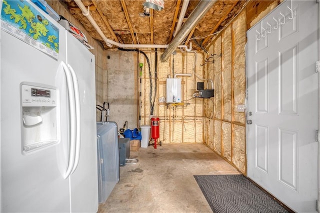 unfinished basement with water heater and white refrigerator with ice dispenser