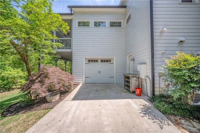 view of side of property with a garage and driveway