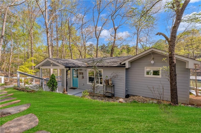 back of property featuring a lawn