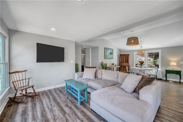 living room featuring baseboards, plenty of natural light, wood finished floors, and lofted ceiling