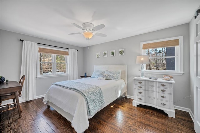 bedroom with baseboards, multiple windows, ceiling fan, and dark wood-type flooring
