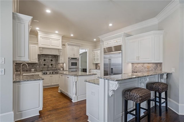 2260 Wood Falls Dr, Cumming, GA 30041 - kitchen featuring a sink, stainless steel appliances, white cabinetry, a peninsula, and tasteful backsplash