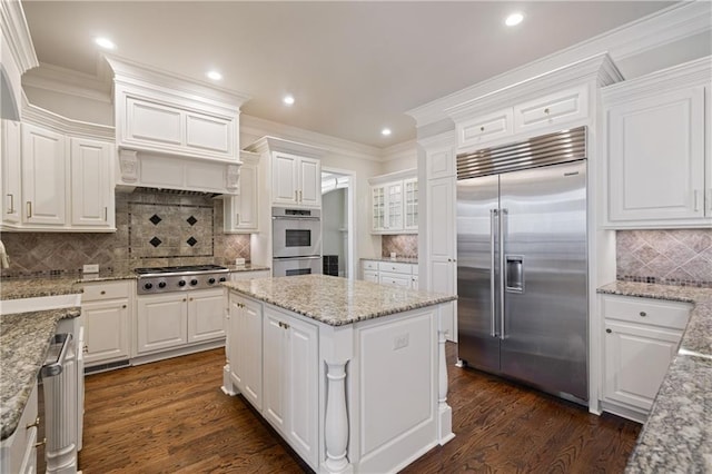 2260 Wood Falls Dr, Cumming, GA 30041 - bar featuring backsplash, fridge, a premium fireplace, and dark wood-type flooring