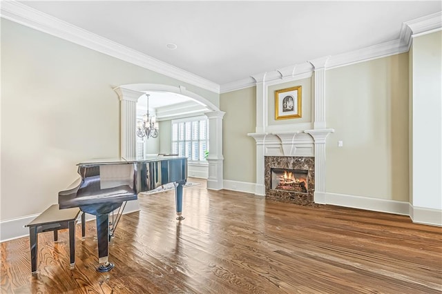 2260 Wood Falls Dr, Cumming, GA 30041 - dining area featuring a raised ceiling, a chandelier, a wainscoted wall, wood finished floors, and ornamental molding