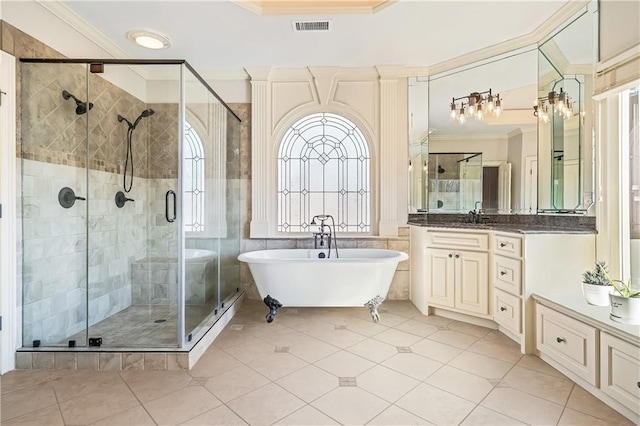 2260 Wood Falls Dr, Cumming, GA 30041 - bathroom featuring tile patterned flooring, a freestanding tub, visible vents, ornamental molding, and a stall shower