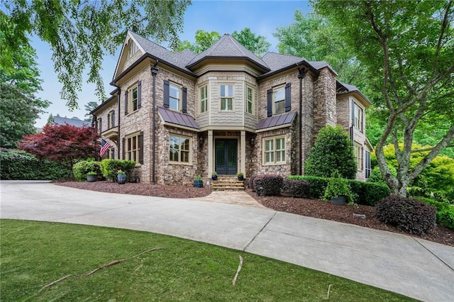 2260 Wood Falls Dr, Cumming, GA 30041 - view of front of property with a shingled roof, a front lawn, stone siding, and a standing seam roof