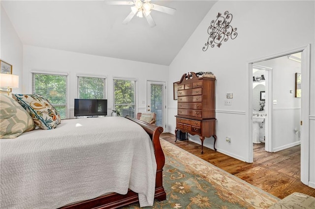 bedroom featuring wood finished floors, high vaulted ceiling, ceiling fan, baseboards, and a sink