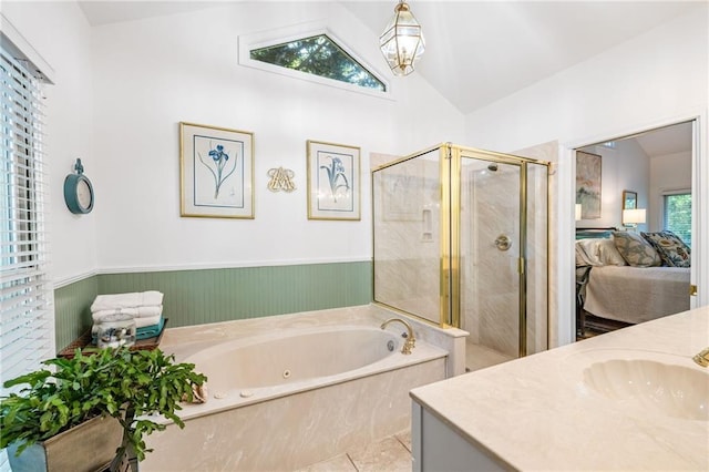 ensuite bathroom with lofted ceiling, a stall shower, a bath, vanity, and tile patterned floors