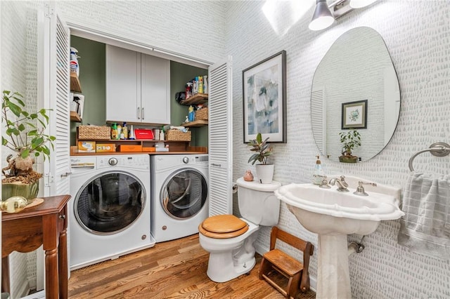 laundry room with separate washer and dryer and wood finished floors