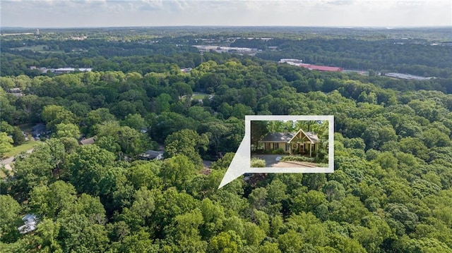 aerial overview of property's location featuring a heavily wooded area and property parcel outlined