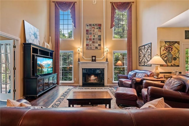 1360 Woodvine Way, Alpharetta, GA 30005 - living area with a towering ceiling, wood finished floors, and a premium fireplace