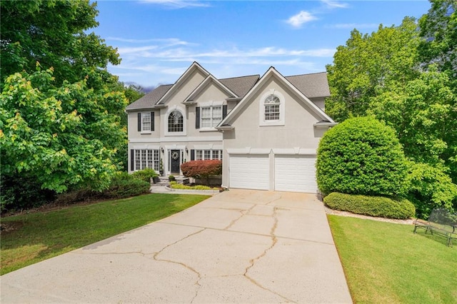 1360 Woodvine Way, Alpharetta, GA 30005 - traditional-style house with a garage, a front yard, stucco siding, and concrete driveway