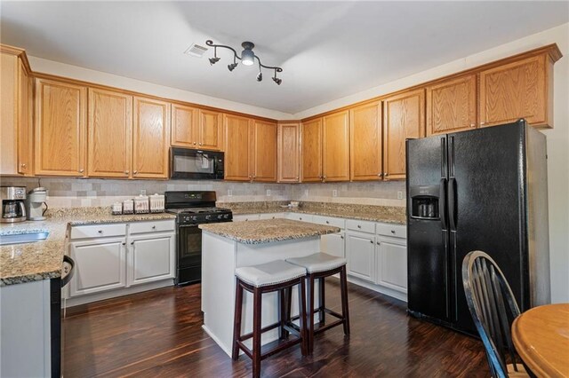 1360 Woodvine Way, Alpharetta, GA 30005 - kitchen featuring black appliances, dark wood-style floors, decorative backsplash, and light stone counters