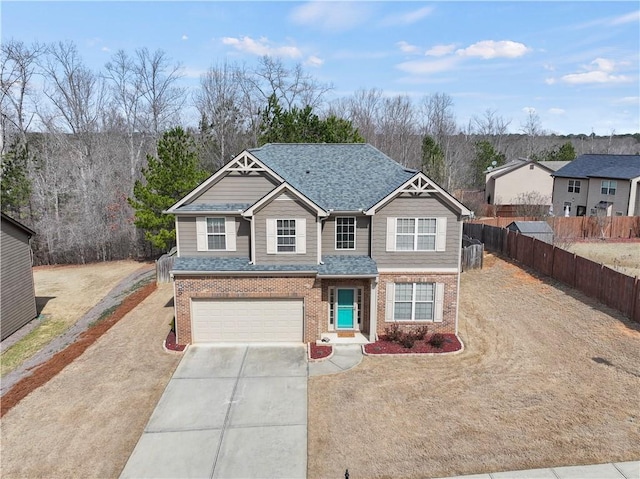 view of front of property featuring a garage, a shingled roof, concrete driveway, fence, and brick siding