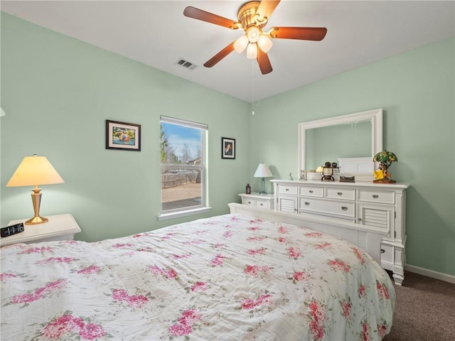 carpeted bedroom with ceiling fan, visible vents, and baseboards