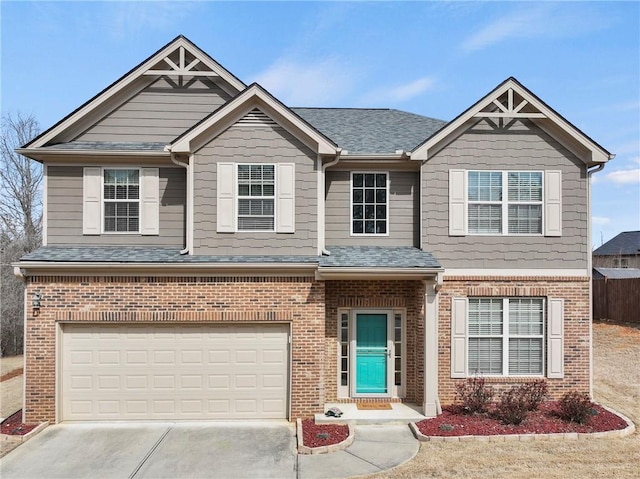 view of front of house featuring a garage, driveway, brick siding, and a shingled roof