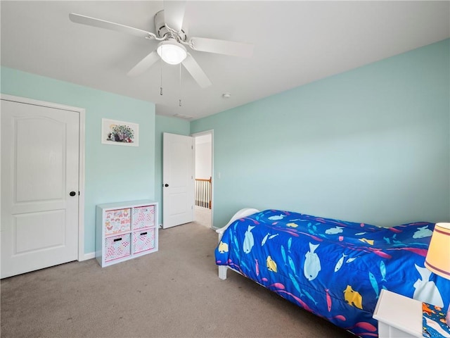 bedroom featuring a ceiling fan, carpet flooring, and baseboards