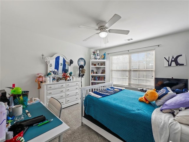 carpeted bedroom featuring ceiling fan and visible vents