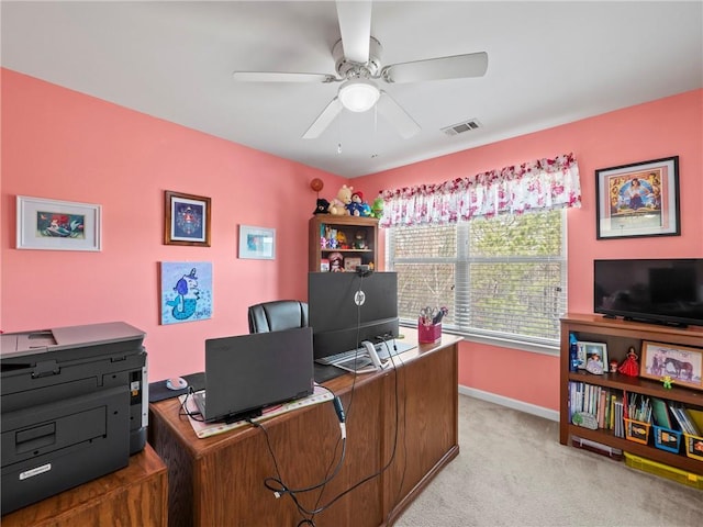 home office with ceiling fan, visible vents, baseboards, and light colored carpet