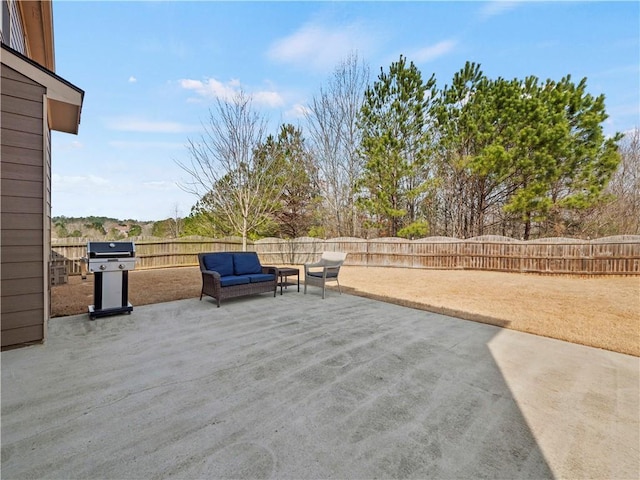 view of patio with grilling area, a fenced backyard, and an outdoor living space