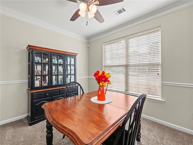 dining area featuring light carpet, plenty of natural light, and visible vents