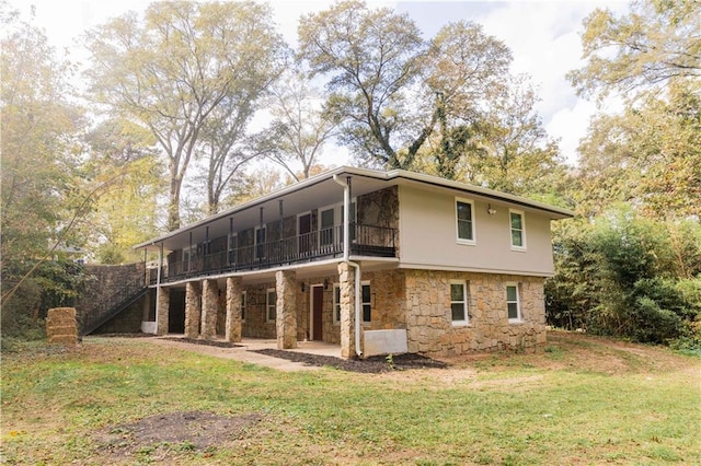 back of property featuring a patio area and a yard