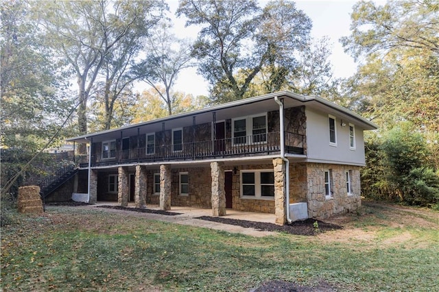 back of property with a patio and a lawn