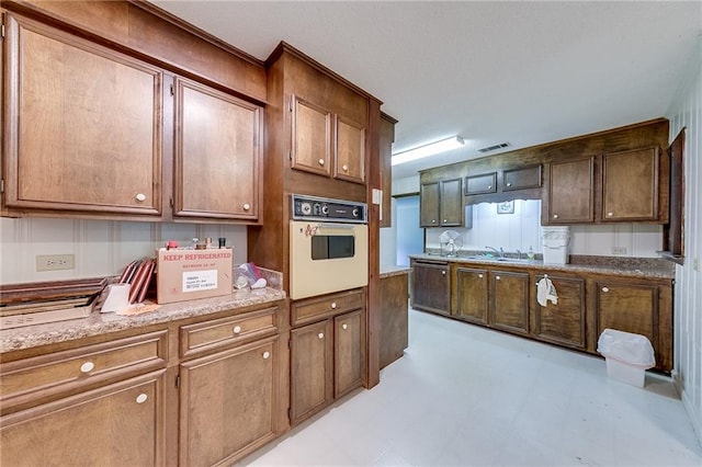 kitchen featuring white oven and sink