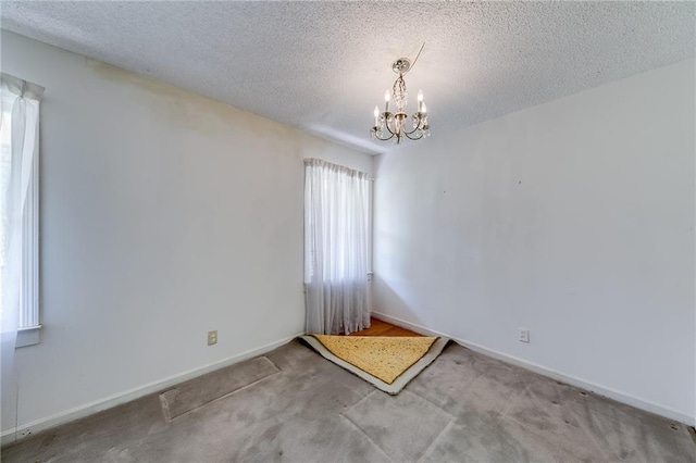 spare room with light carpet, a textured ceiling, and a healthy amount of sunlight