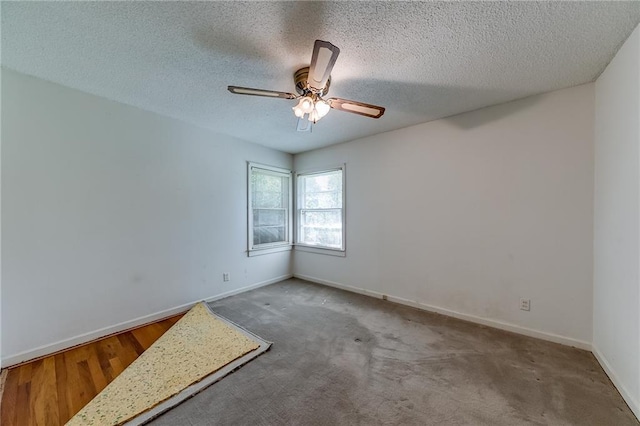 carpeted spare room with ceiling fan and a textured ceiling