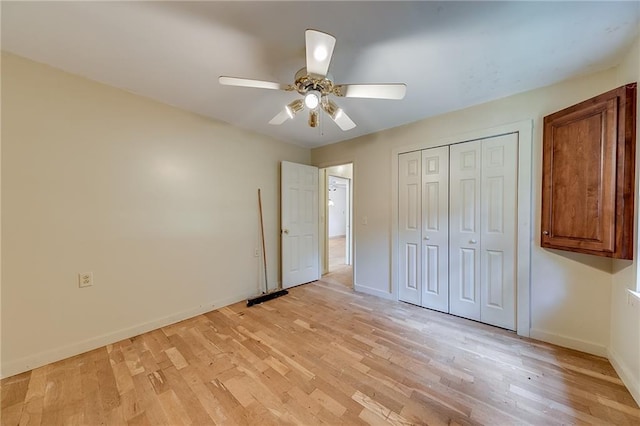 unfurnished bedroom with a closet, light wood-type flooring, and ceiling fan