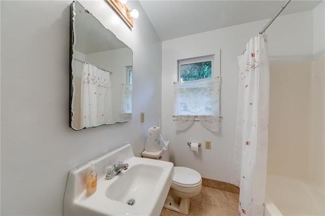 full bathroom featuring sink, tile patterned flooring, toilet, and shower / bathtub combination with curtain