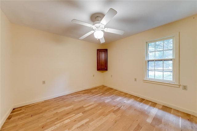 spare room featuring light wood-type flooring and ceiling fan